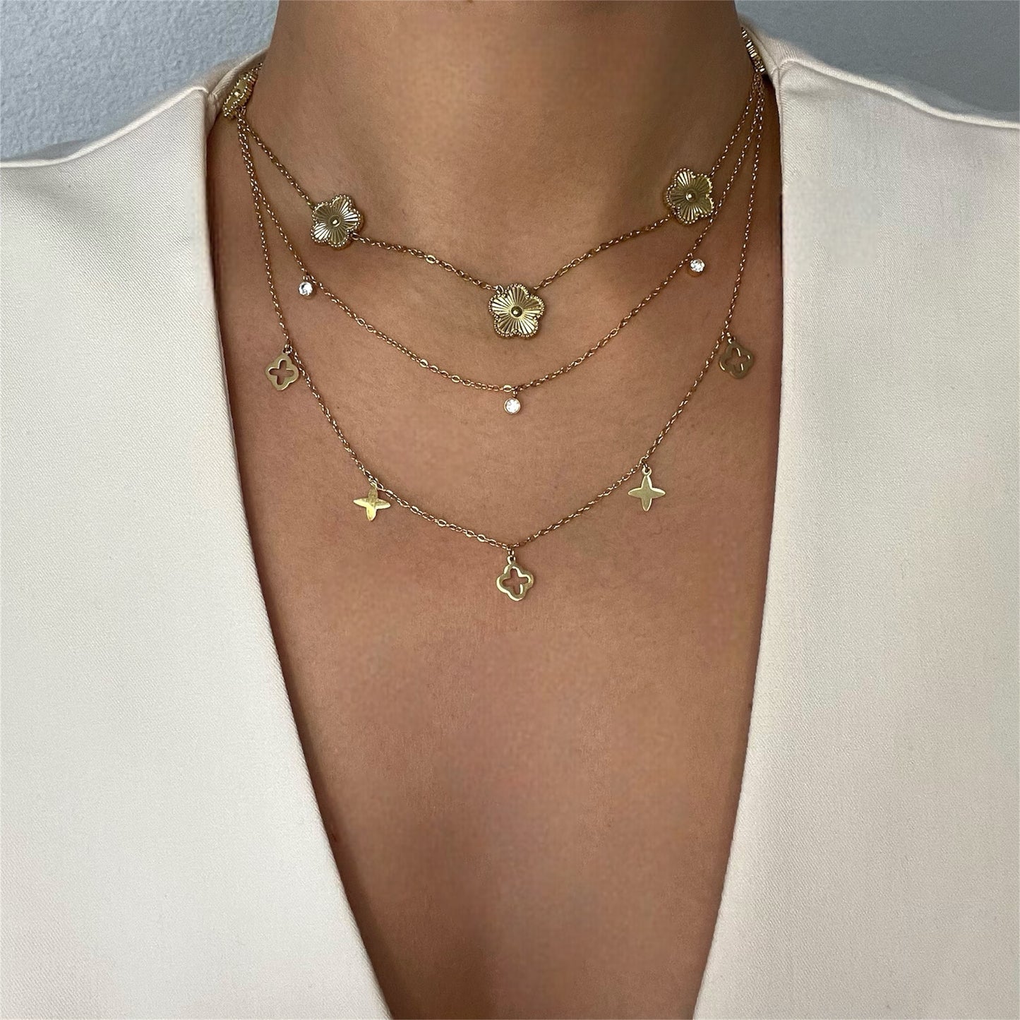 Collier deux rangs trèfles et étoiles en acier doré pour femme